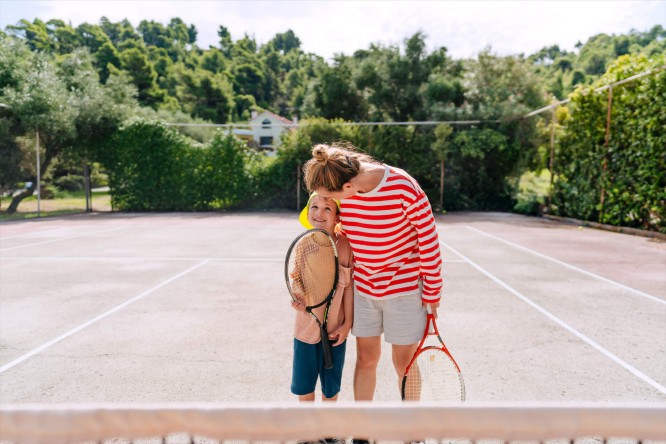 Mother and child at a tennis court